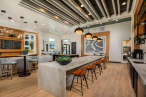 demonstration kitchen at the community lounge with modern lighting and a television