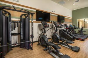 Delhaven Pointe fitness center with cardio equipment and televisions