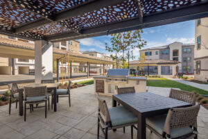 outdoor space with tables, chairs and a grill