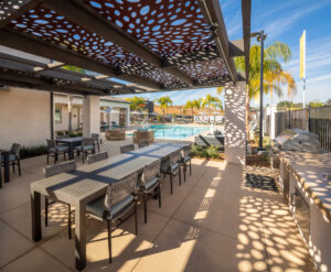 outdoor resident lounge in Murrieta, CA with grills, tables and a swimming pool