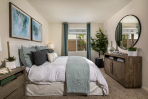 Murrieta, CA Apartments Near Old Town Temecula - Delhaven Pointe - Bedroom with Plush Carpeting, a Large Window, and a King Size Bed in the Middle of the Room