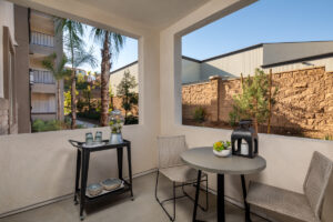 bright apartment balcony with a table and breakfast cart