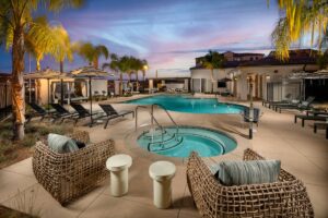 Two-Bedroom Apartments in Murrieta, CA - Delhaven Pointe - Swimming Pool with a Spa, Covered Daybeds, and Lounge Seating