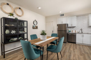 wooden kitchen table with blue chairs at Delhaven Pointe